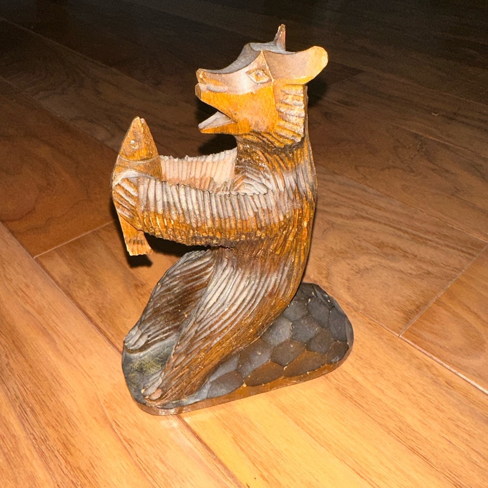 Wooden bear with fish.